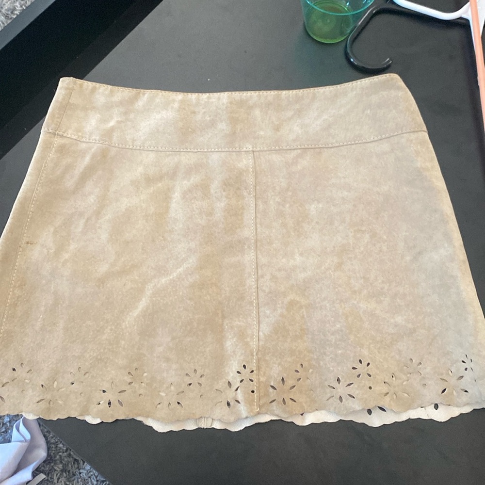 100% leather Arden B. Tan mini skirt with beautiful detail on bottom. Size 4.